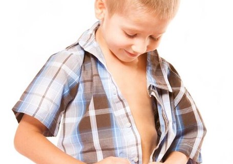 Photo image of a child buttoning up their shirt (Shutterstock image)