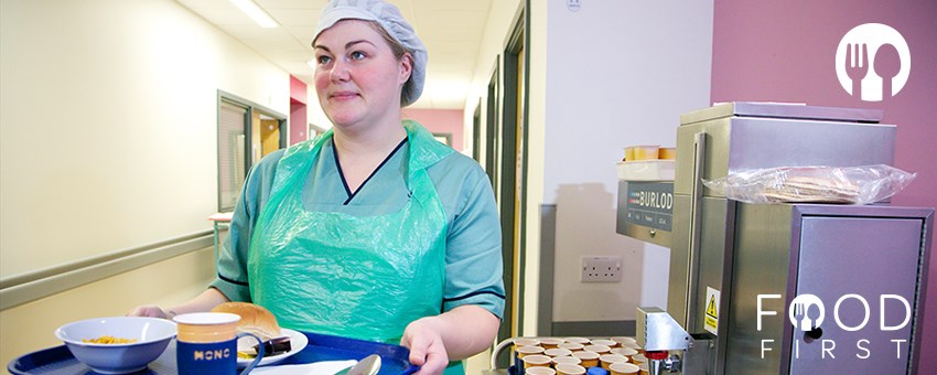 Food First - Facilities Assistant with breakfast tray