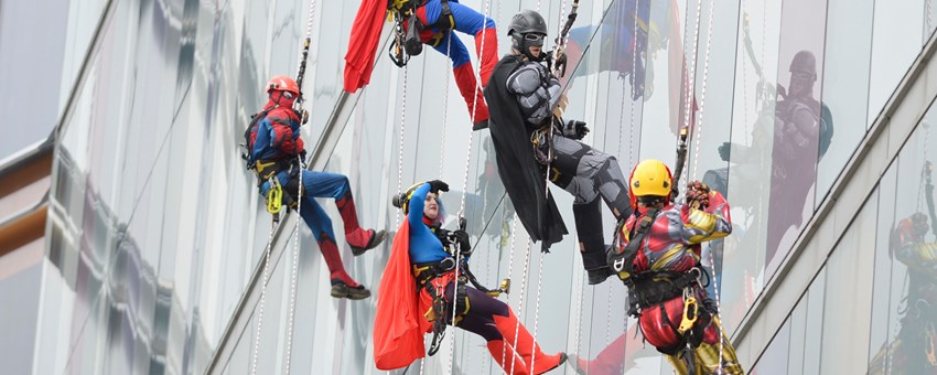 RHC patients marvel as superheroes descend building in charity abseil stunt 